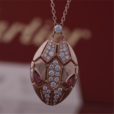 Roman Serpenti necklace in 18 kt rose gold set with rubellite eyes and with pavé diamonds on the head