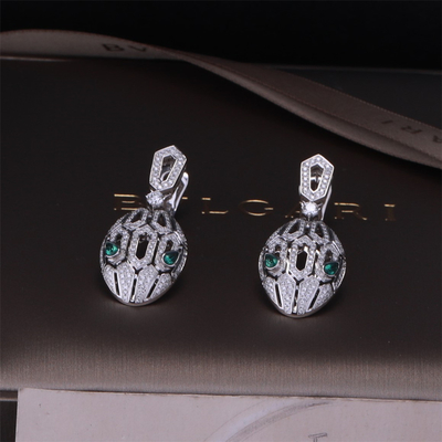 Luxury Gold Brand Serpenti Earrings in 18K White Gold set with Emerald Eyes and with pavé diamonds Snake Head