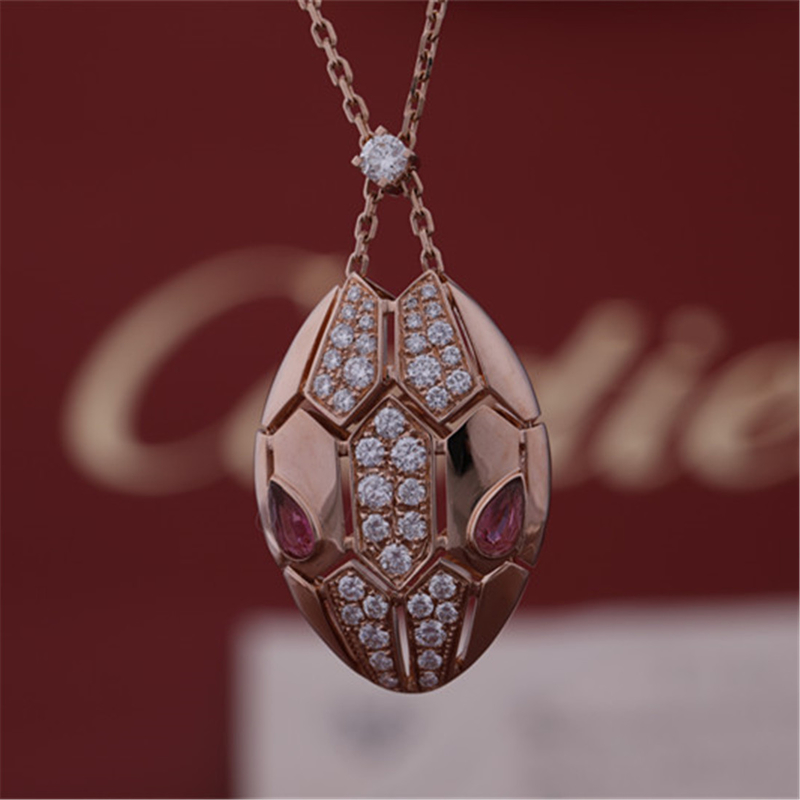 Roman Serpenti necklace in 18 kt rose gold set with rubellite eyes and with pavé diamonds on the head